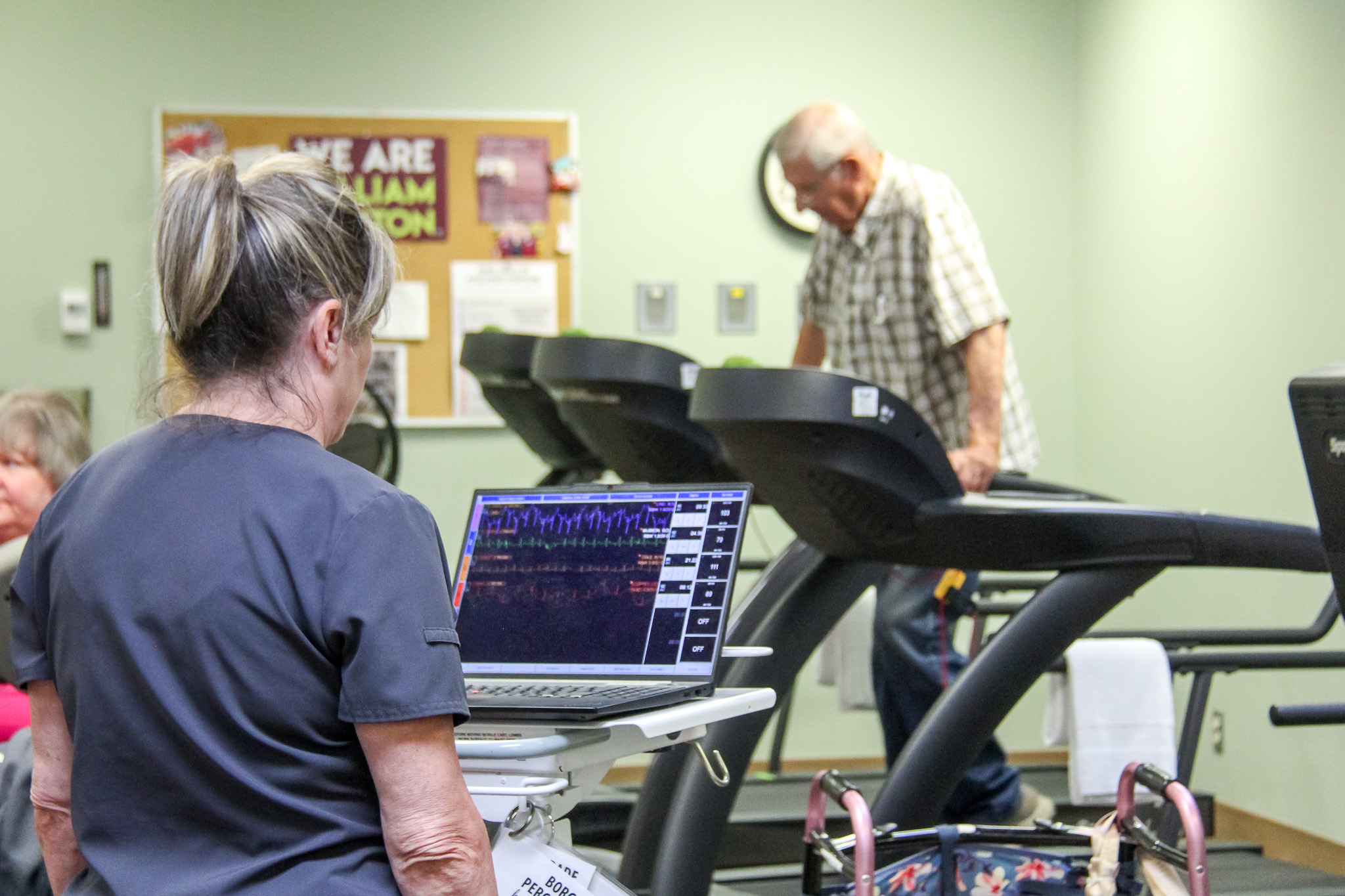 Nurse takes blood pressure while patient is exercising