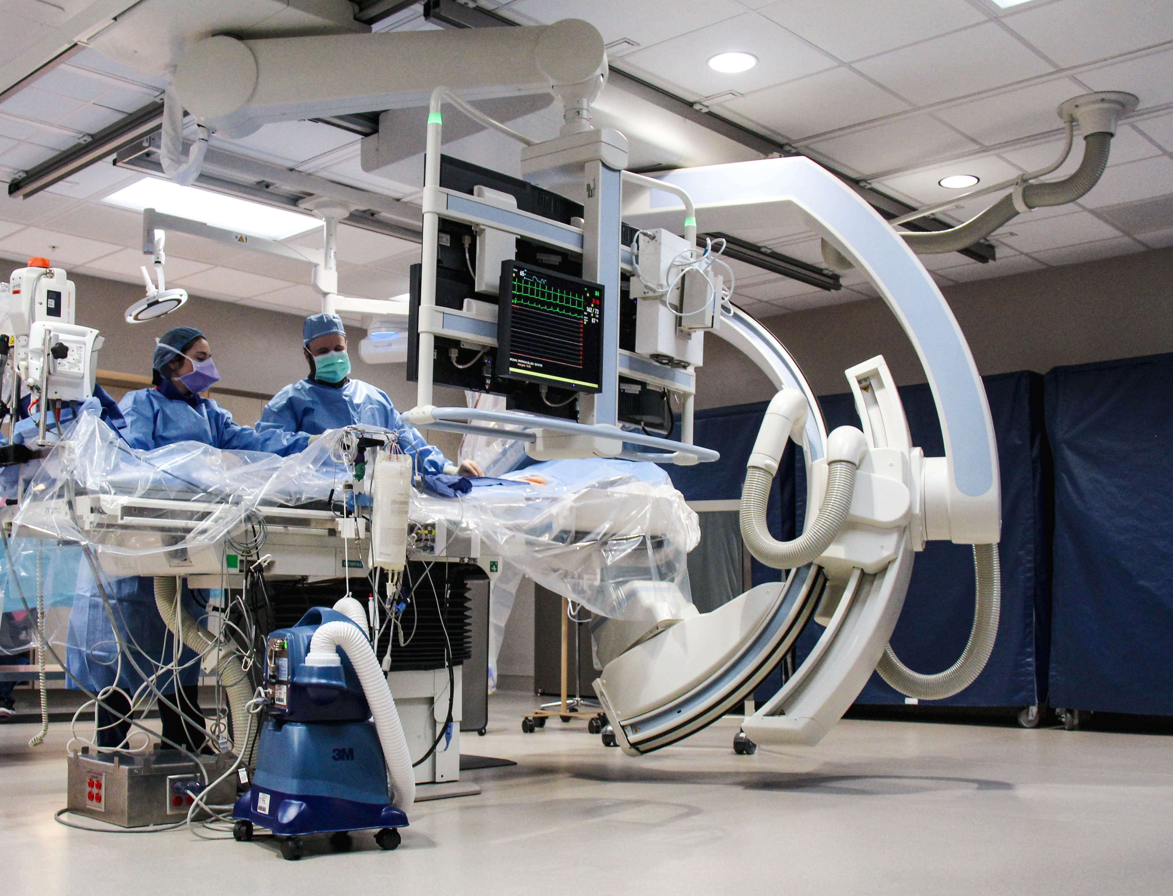 Rebecka, RTR, and Ryan Beard, MD perform a procedure in the cardiac catheterization lab.