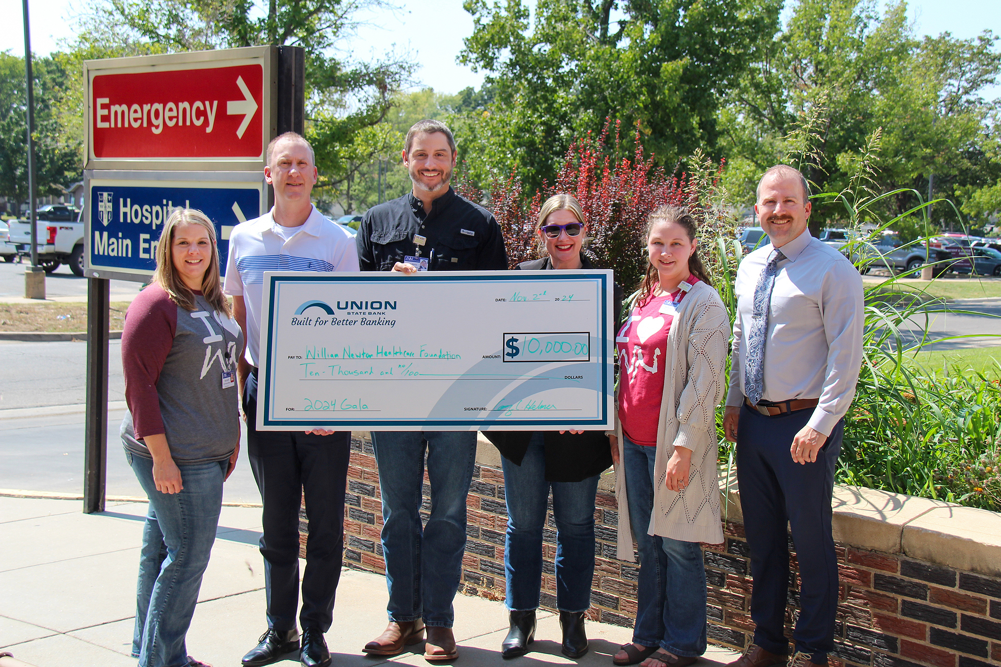 Union State Bank presents a $10,000 check for the renewal of its annual sponsorship benefiting William Newton Healthcare Foundation. From left: William Newton Hospital Chief Financial Officer Kara Goff, Union State Bank Winfield Market President Cory Helmer, William Newton Hospital Chief Executive Officer Brian Barta, William Newton Healthcare Foundation Executive Director Annika Morris, William Newton Healthcare Foundation Assistant Miranda Nation Hofmeister, and Union State Bank Vice President/Mortgage Lender Rusty Zimmerman.