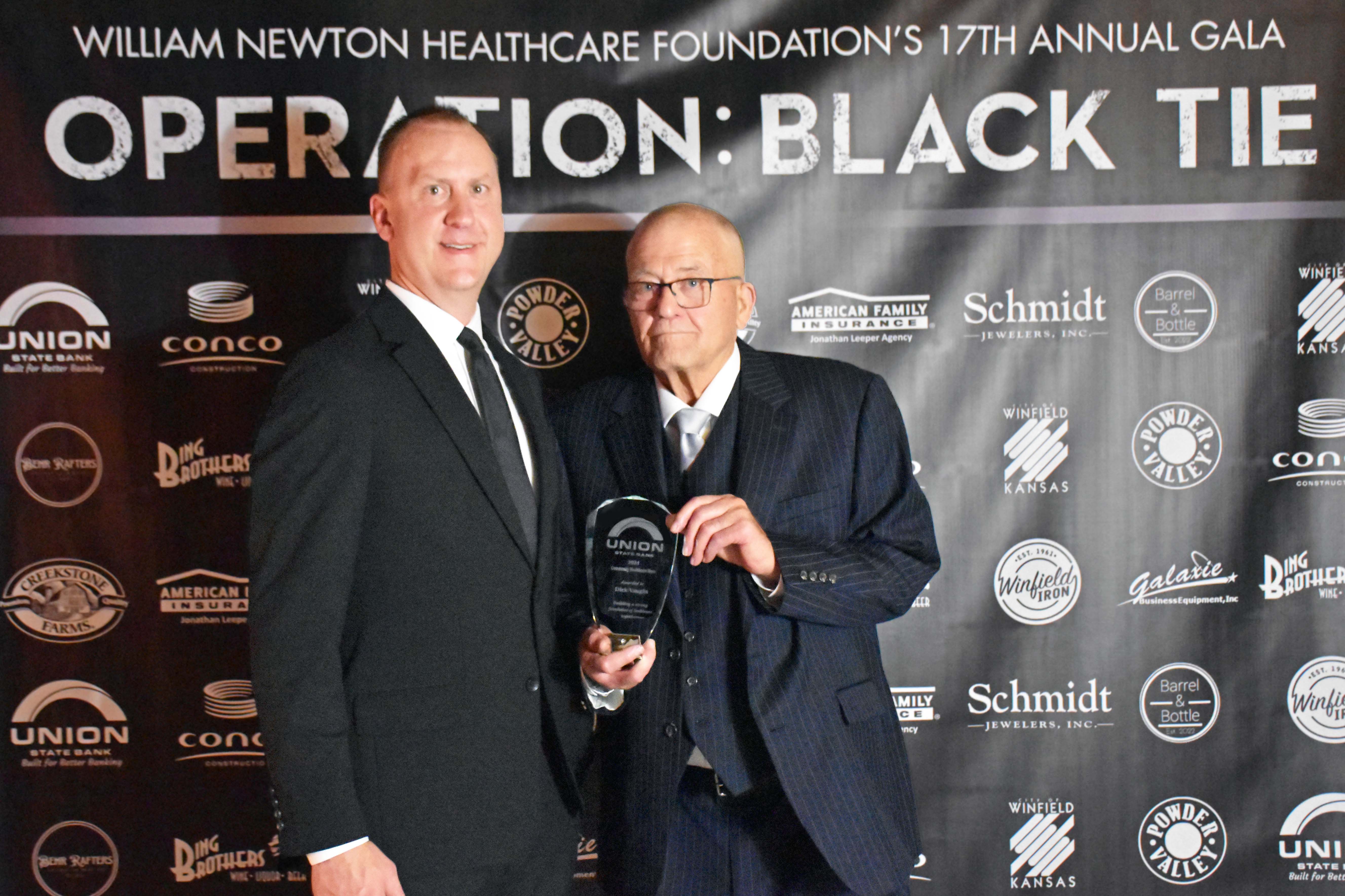 Dick Vaught, right, receives the 2024 Healthcare Hero Award from Union State Bank Winfield/Udall Market President Cory Helmer at the annual William Newton Healthcare Foundation gala.