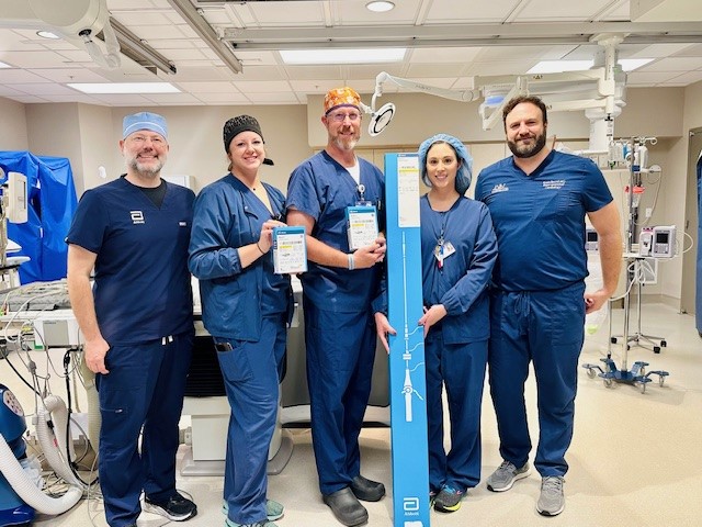 From left, Dan Buchmueller, Abbott Regional Leadless Clinical Specialist, shows off the innovative equipment in the cardiovascular catheterization lab with William Newton Hospital team members Sarah Cooper, RTR, Steven Kramp, RN, Rebecka Tebben, RTR, and Ryan Beard, MD.