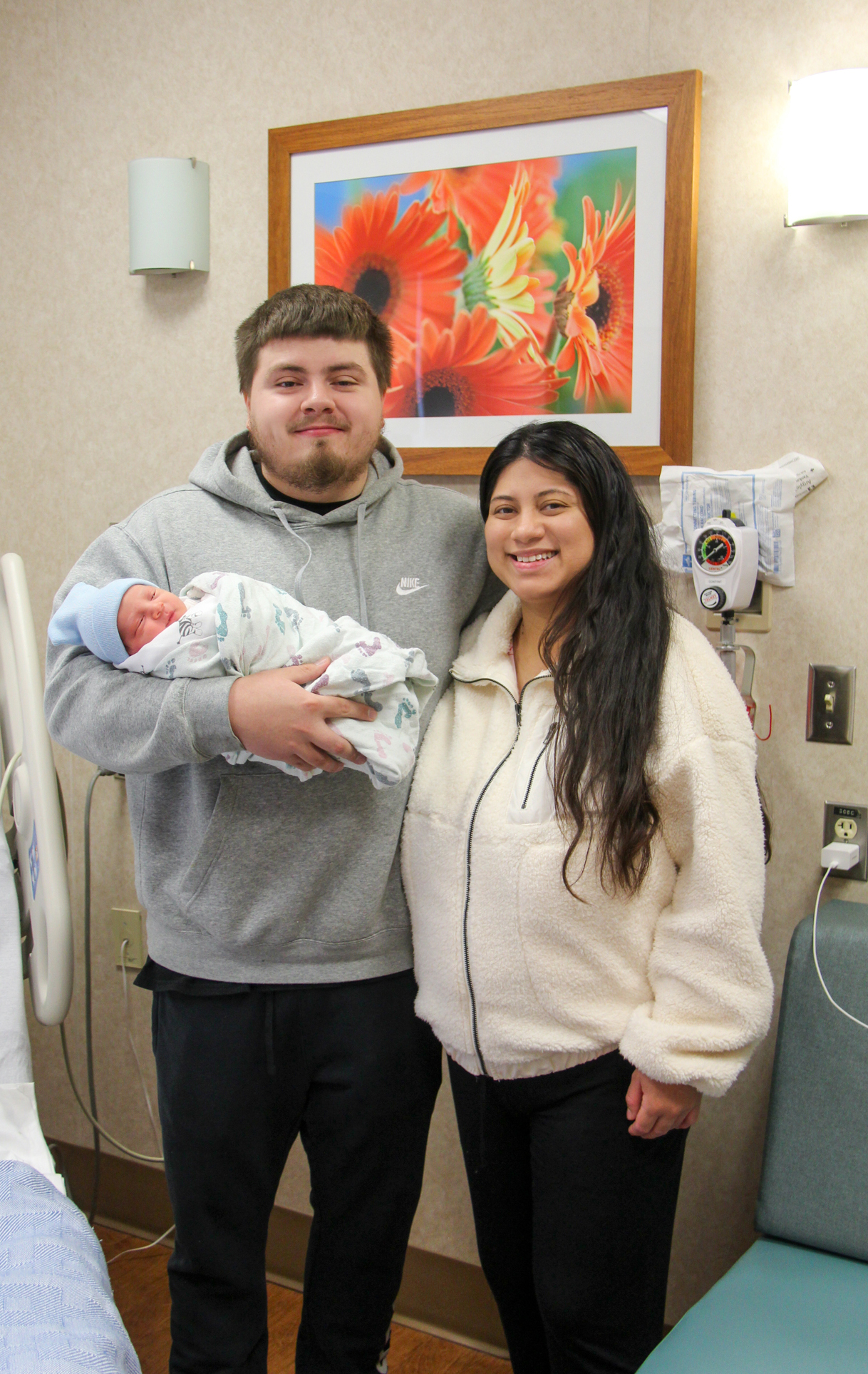 Each born on holidays, the family prepares to go home after delivering on New Year’s Day at the William Newton Hospital Family Birthing Center.