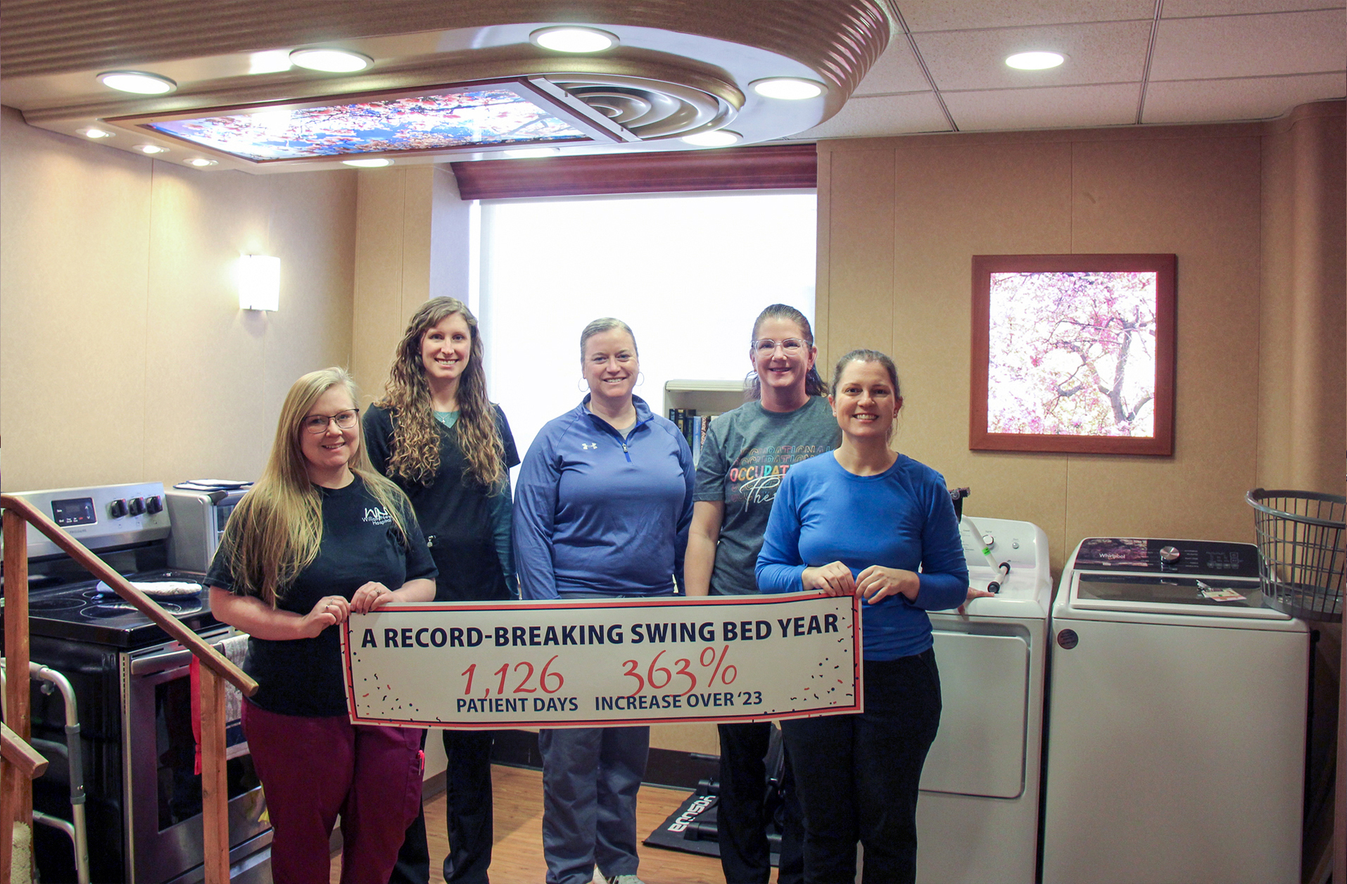 Rehabilitation services staff including physical and occupational therapists gather in the recently added inpatient treatment room.